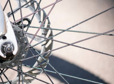 A closeup shot of the metal beams connecting the mechanism details of a bike wheel