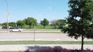 An HD of a cityscape, the cars, buildings and parks