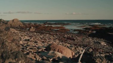 The morning on a rocky beach at sunrise