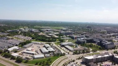 A 4K of a city lifestyle, with driving cars, buildings and vegetation