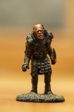 A selective focus shot of an orc figurine from the Lord of the Rings movie