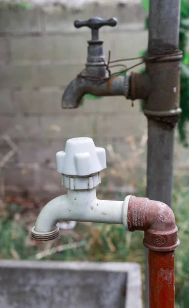 Details of new and old water faucets and pipelines (focus on plastic one)