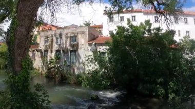 A beautiful slow-motion footage of the Almond river in the downtown city at Portugal