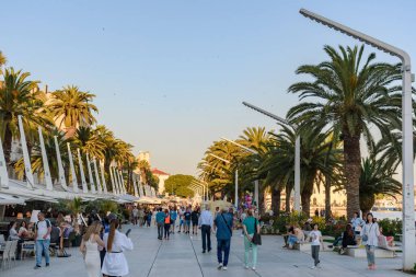 A group of tourists on promenade walk called Riva in city of Split in Croatia.