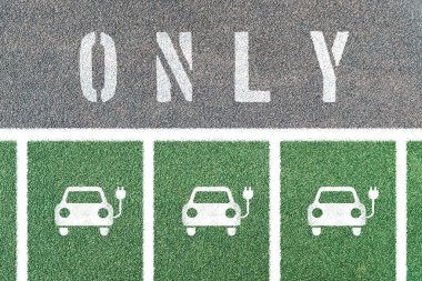Multiple electric car only parking with symbols. Electric vehicle charging station with electric plug icon.