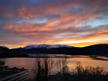 A breathtaking view of the Samnangerfjord in Samnanger on colorful sunset sky background