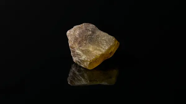 Closeup Uncut Raw Orange Meliphanite Stone Reflective Black Surface — Stock Photo, Image