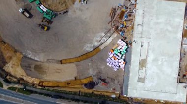A drone shot of a construction area with a crane and devices