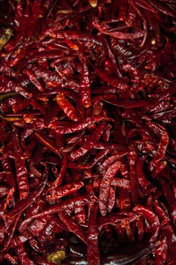 Chiles de arbol placed on a shelf for sale within a market