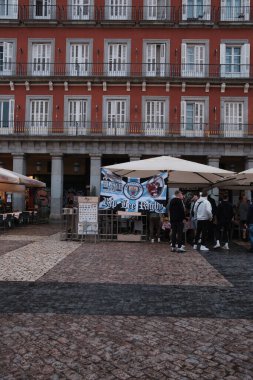 Manchester City fans with posters gathered on a street at Plaza Mayor in Madrid