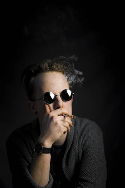 Vertical Shot Smoking Young Guy Wearing Black Sunglasses Isolated Black — Fotografia de Stock