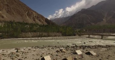 Beautiful Drone footage of Gilgit Baltistan Pakistan's most beautiful velley with huge mountains and Heavy clouds with flowing river Pakistan