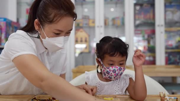 Young Thai Female Teacher Mask Helping Child Mask Building Toys — Wideo stockowe