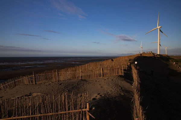 A row of industrial wind turbines on the Caota Dune Beach in Taiwan