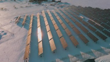 An aerial view of solar panels in nature in winter in HD