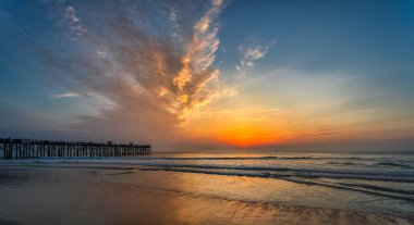 A beautiful view of Flagler Beach Fishing Pier at sunrise in Florida, USA