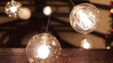 A selective focus shot of light bulbs hanging from the ceiling as decoration for a celebration party