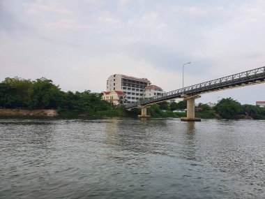 A long bridge over a river in a city