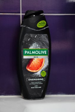 A vertical shot of Palmolive Men brand Energising shower gel in a plastic bottle.