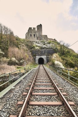 The train rails with the Lowenburg in the background in Monreal