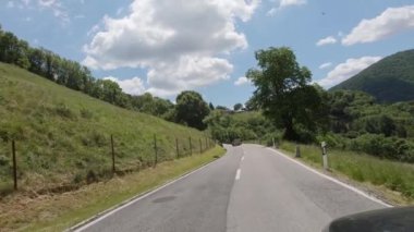 A car driving a mountain road in nature, forest, green, Ticino, Switzerland, Valle di Muggio