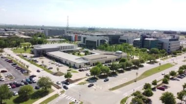 A 4K of a city lifestyle, with driving cars, buildings and vegetation