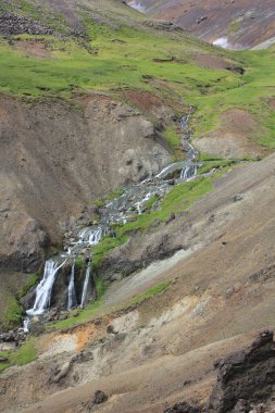 Waterfall in beautiful and dramatic volcanic landscape (vertical), Hveragerdi, Iceland