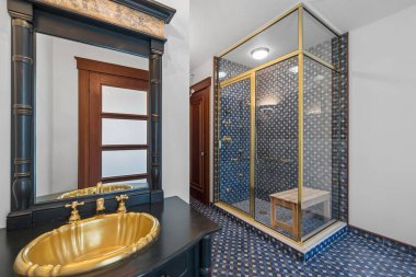 A modern luxury bathroom design with a glass-walled shower area