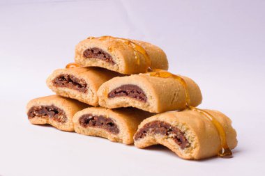 A closeup shot of stacked cookies with chocolate filling