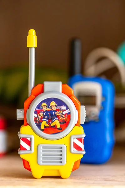 Vertical Closeup Fireman Sam Toy Walkie Talkie Blurred Background Wooden — Stock Photo, Image