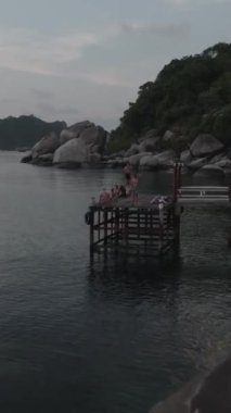 An HD of the people fishing on the pier