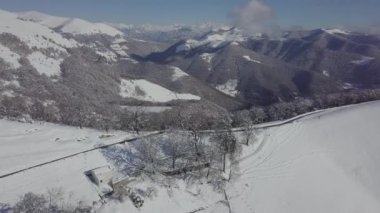 An aerial view of the snowy mountain Monte Generoso in Ticino, Switzerland