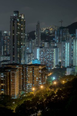 A vertical shot of illuminated buildings at night
