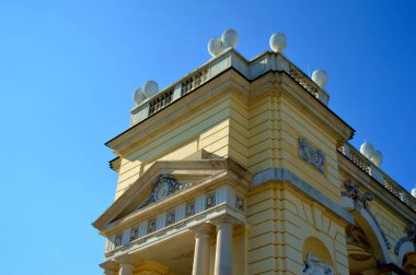 A low-angle shot of the blue sky over the old building on a sunny day