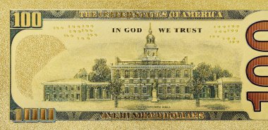 The opposite side of a gold 100 dollar bill for collections
