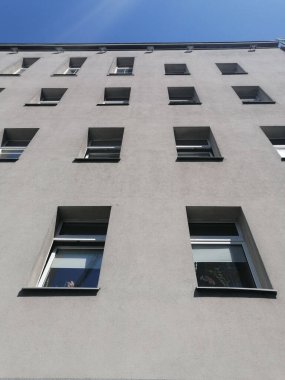 A low angle view of an old office building with many windows in the city center in Poznan, Poland