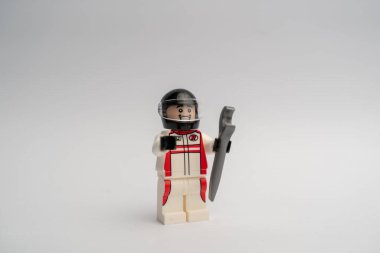 A mini lego figure of a car mechanic against the white background