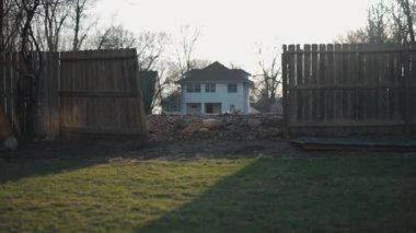 Damaged wooden fence in the backyard