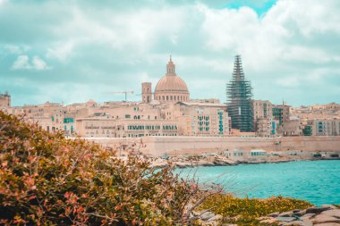 A charming view of St. John's Co-Cathedral and tigne Point from the beach, Manoel Island, Malta