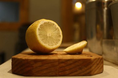 A closeup of the cut lemon on the wooden board. Shallow focus.