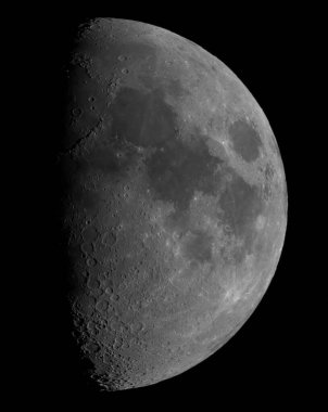 A vertical closeup shot of a waxing half-moon from a telescope on black background
