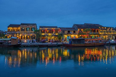 A beautiful shot of illuminated buildings near the water at night in Hoi An, Vietnam