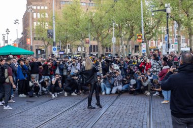 Photographers are trying to get a photo of the model posing on the street