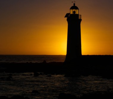 A closeup shot of a lighthouse during sunset in Griffith's island, Canada