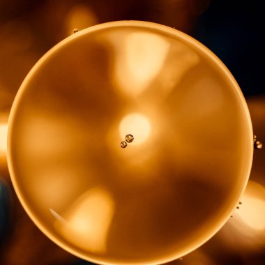 An oil drop over gold back-illuminated droplet