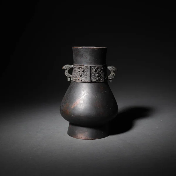 A closeup of an old jar in China isolated on a dark background