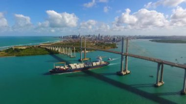 A beautiful view of the Newton Navarro bridge with a ship passing underneath in Natal, Rio Grande do Norte, Brazil