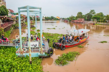 A Thai ferry boat with passengers crosses the Chaophraya River in Ayutthaya Thailand Asia