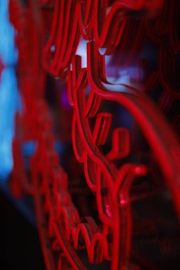 Cam bir yüzeye bağlanmış kırmızı neon ışığın yakın çekim görüntüsü.