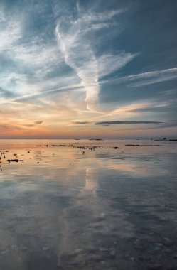 Gün batımının berrak suyun üzerindeki muhteşem yansıması.